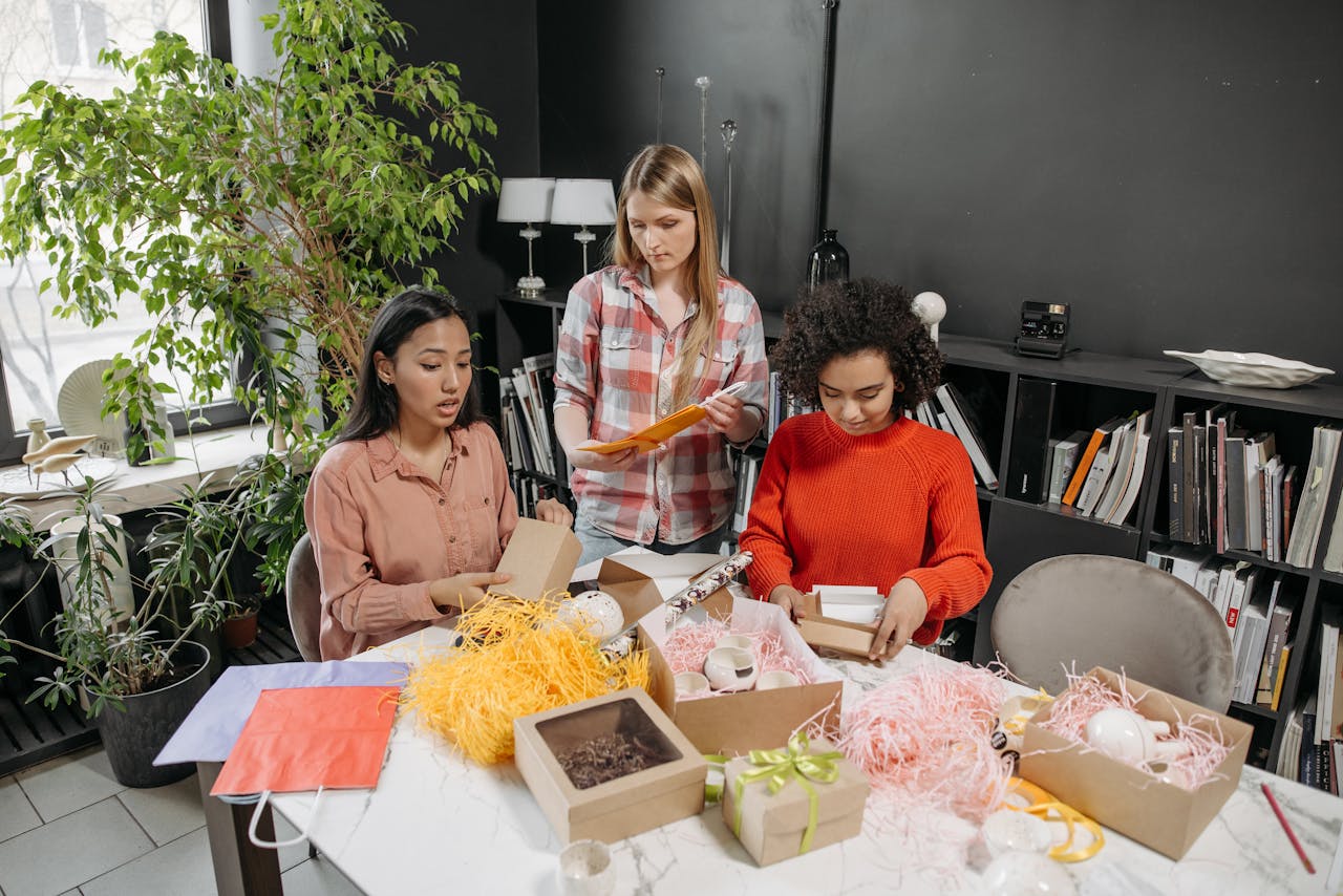 Female team working together on product packaging in a modern office.